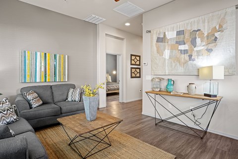 a living room with a gray couch and a coffee table